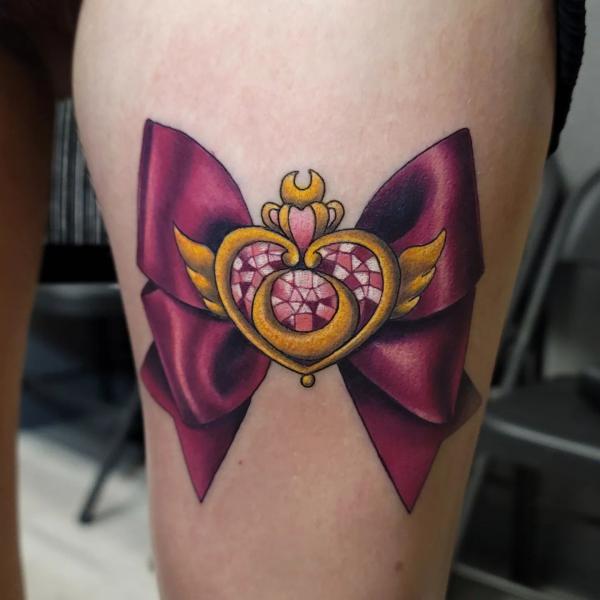 sailor moon bow tattoo on thigh