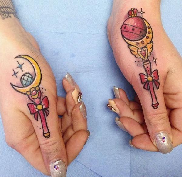 sailor moon wand thumb finger tattoo