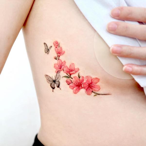 Cherry blossom underboob tattoo by @palette.tt