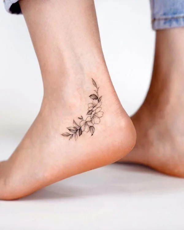 Dainty flowers ankle tattoo by @zeetattoo