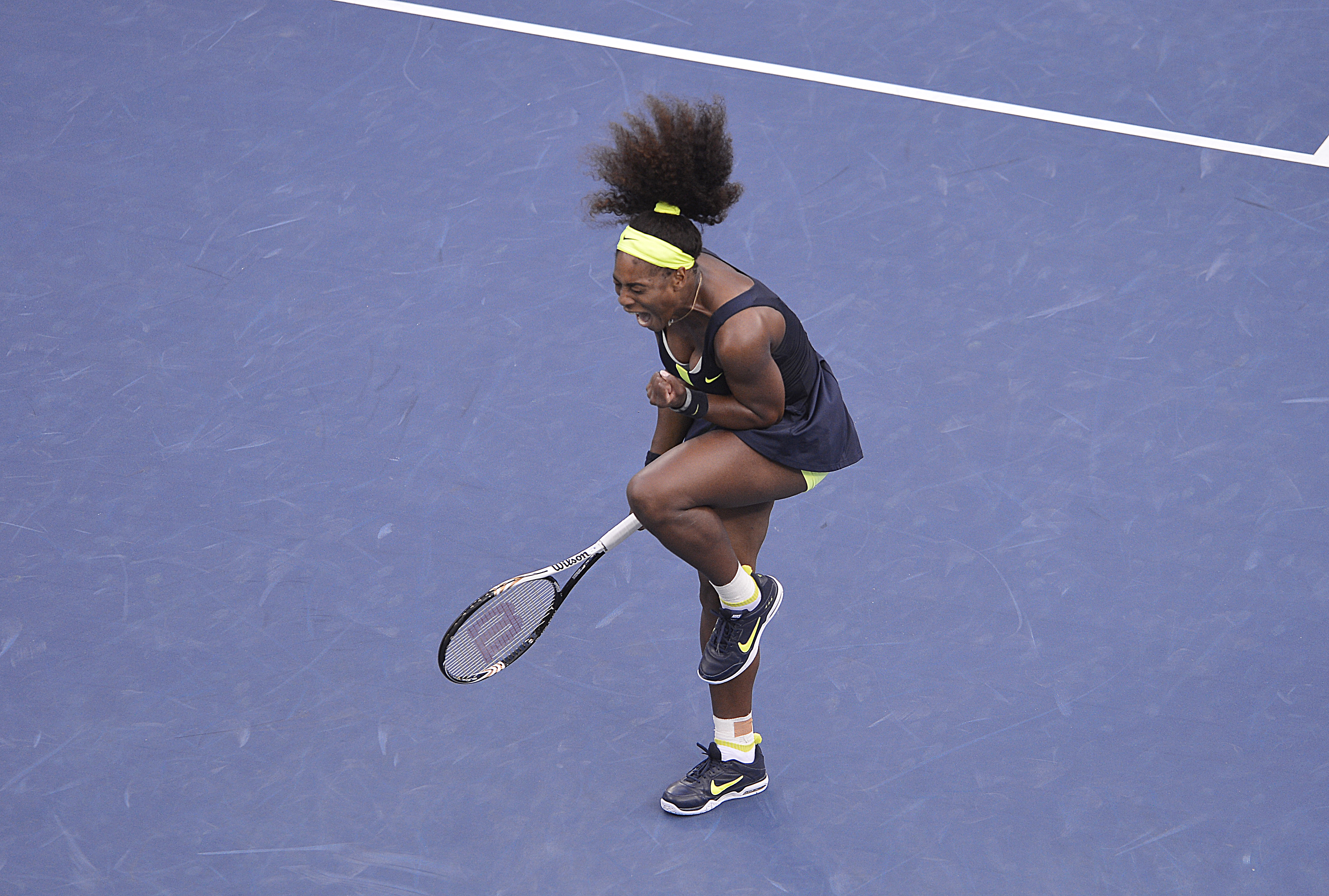 Serena Williams takes a photo with her trophy after defeating Russia's Maria Sharapova in the Women's Final of the French Tennis Open 2013 at Roland-Garros Stadium in Paris, France on June 8, 2013.