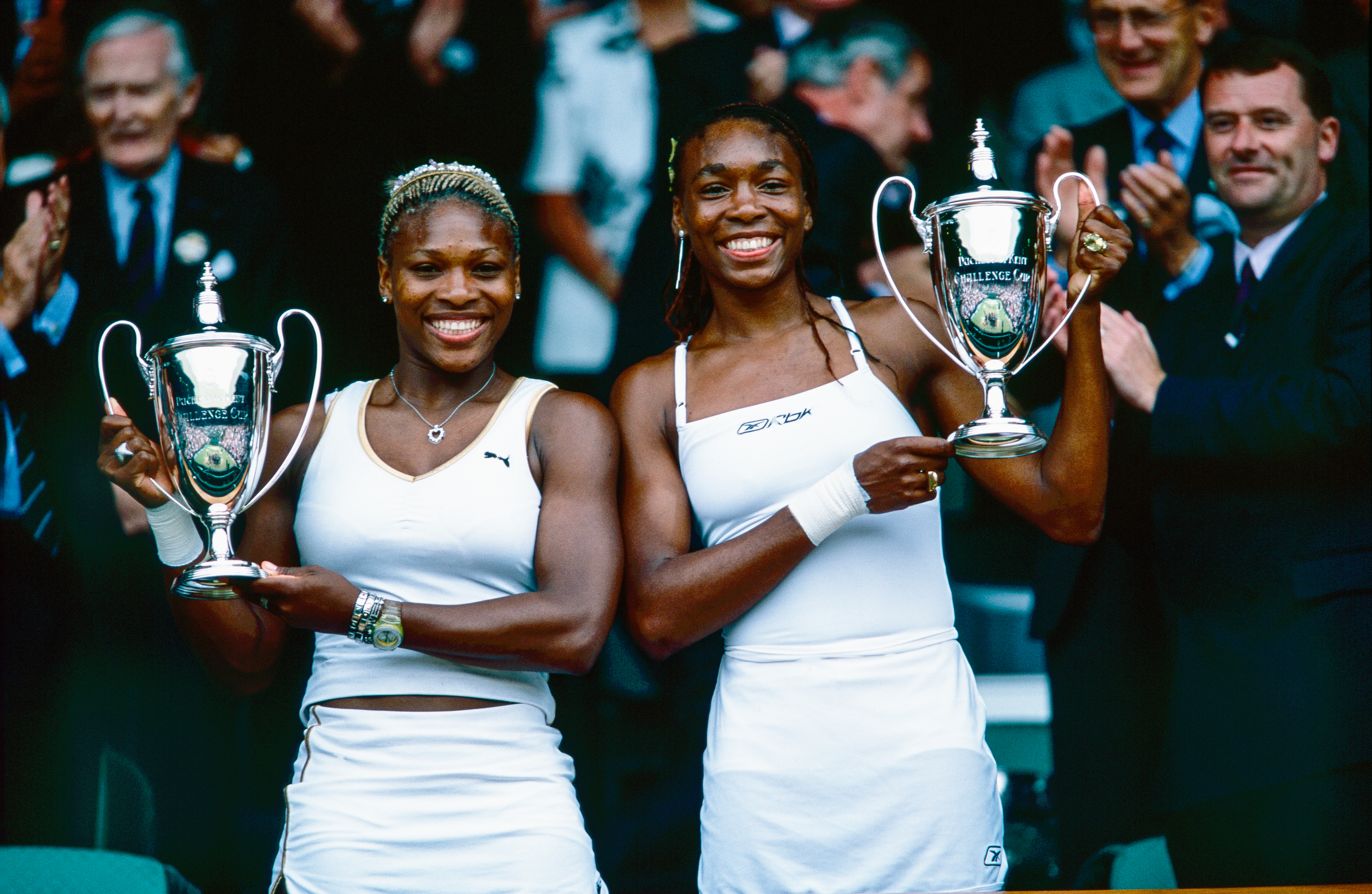 Venus and Serena Williams lift the Women's Doubles trophies at The Wimbledon Lawn Tennis Championship at the All England Lawn and Tennis Club at Wimbledon on July 07, 2002, in London, England.