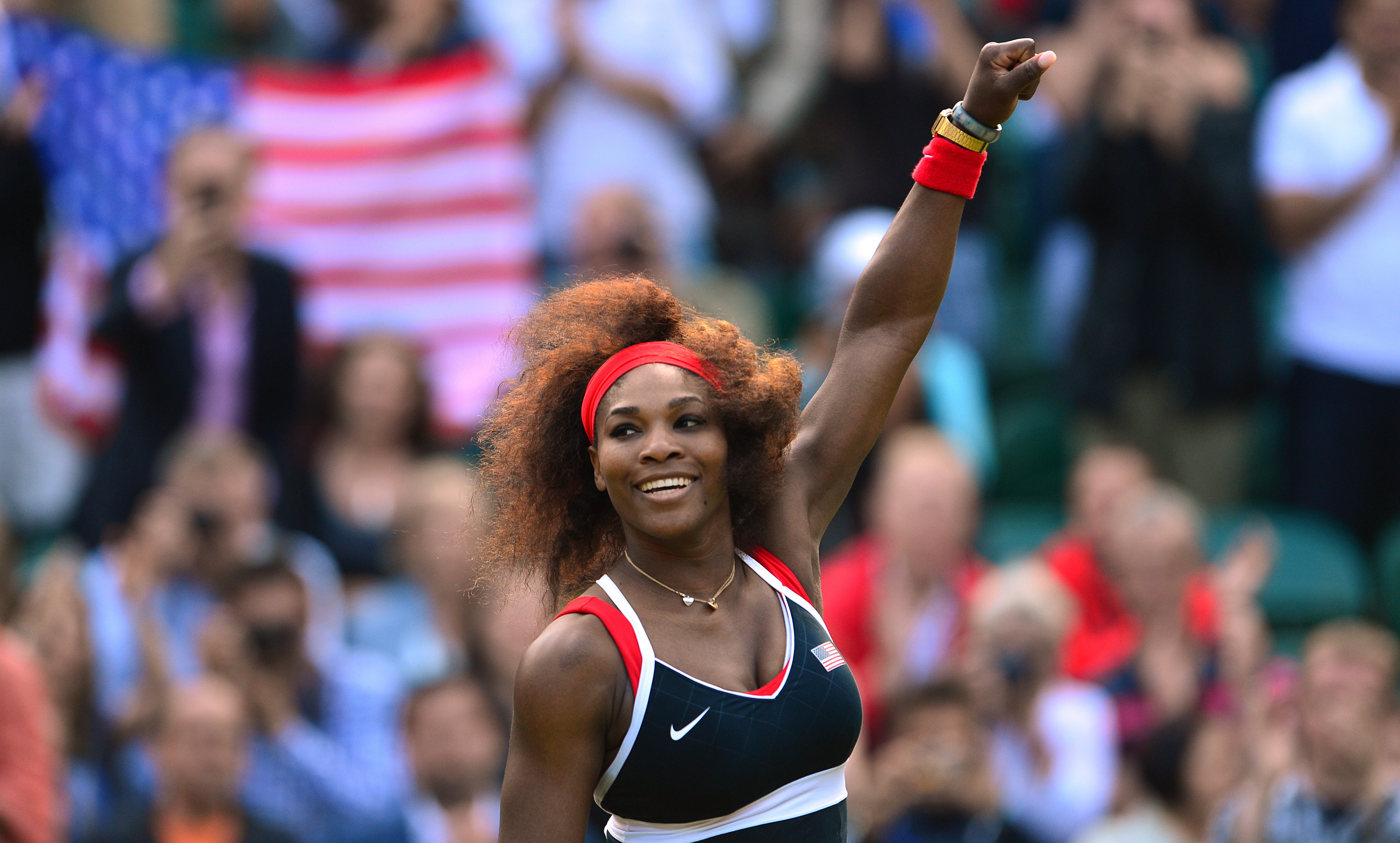 Serena Williams waves to the crowd after a winning her women's singles semifinal round match at the 2012 London Olympic Games.