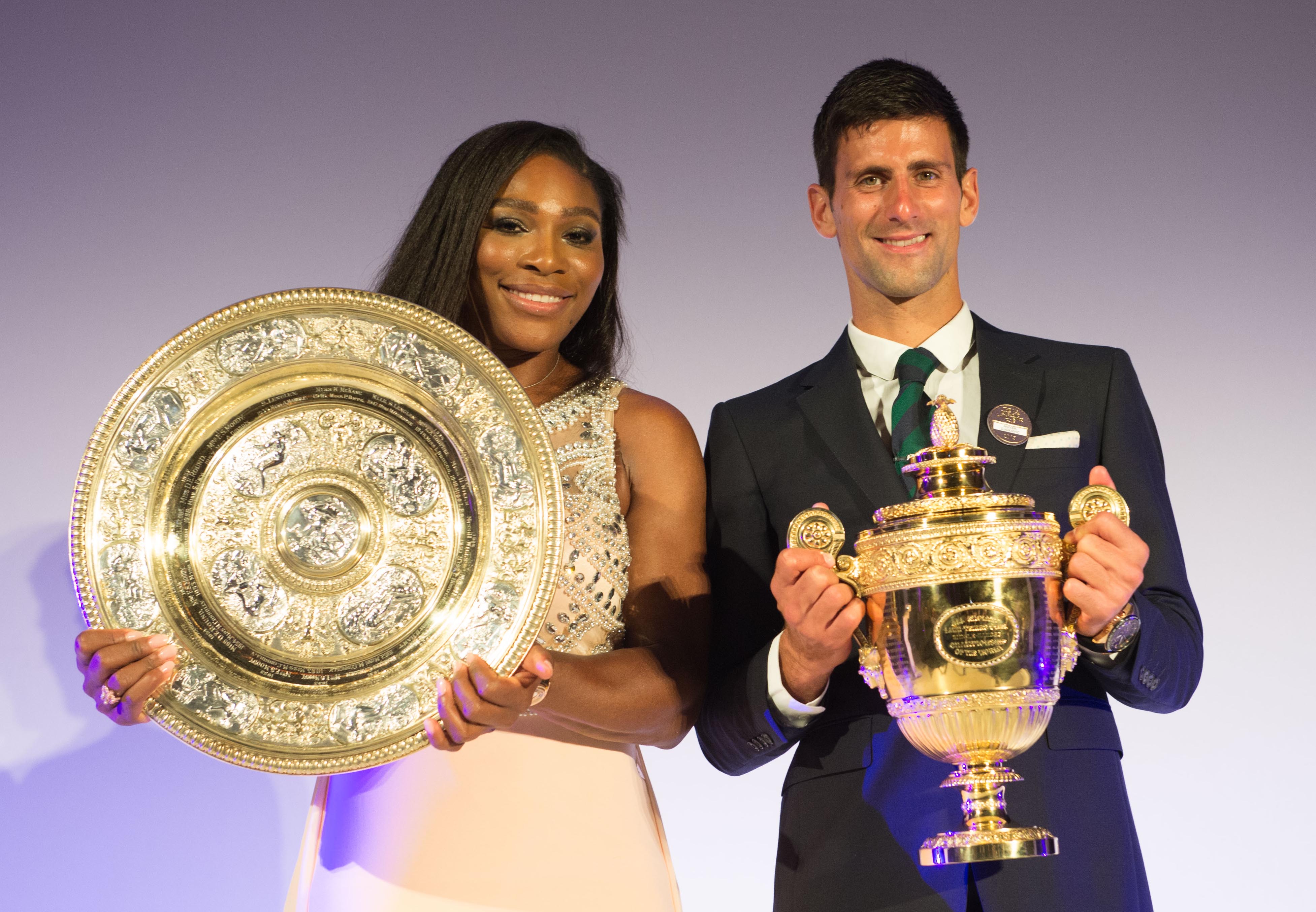 Serena Williams and Novak Djokovic pose on stage during the Champions Dinner at the Guild Hall on July 12, 2015, in London, England.