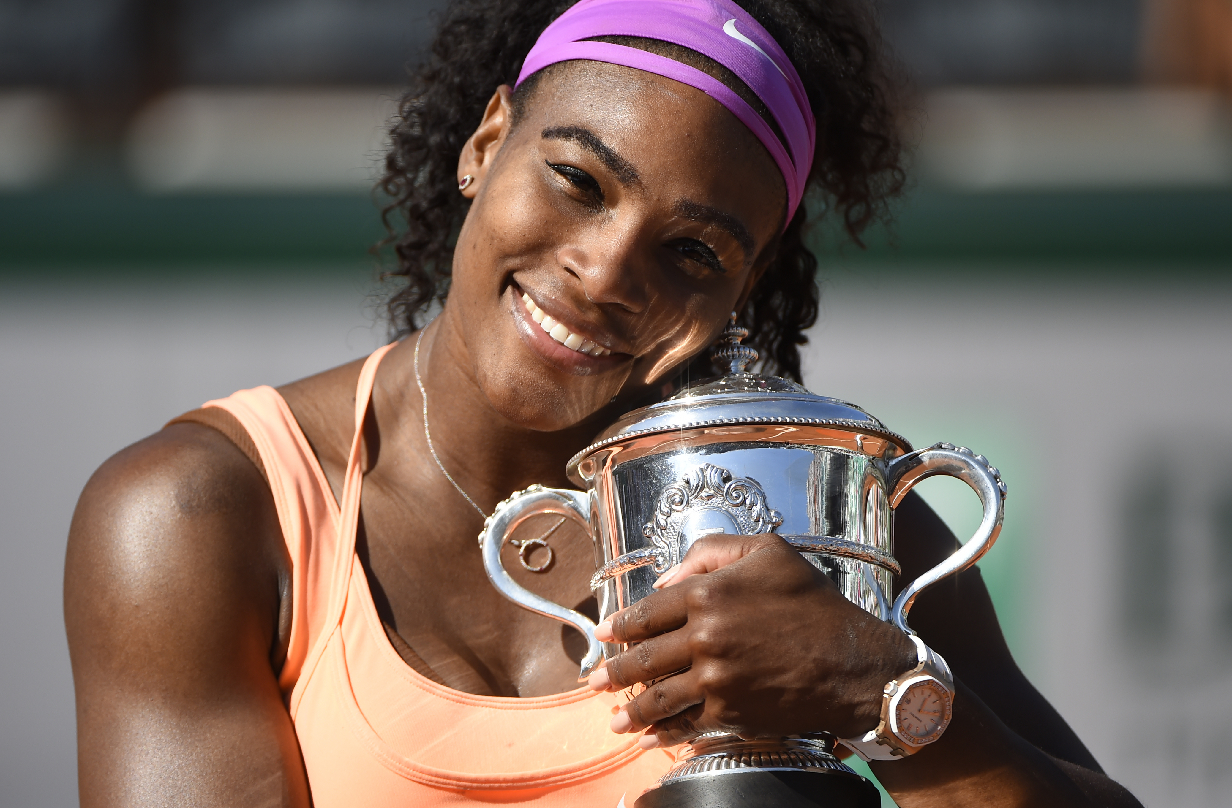 Serena Williams smiles with her trophy during the Women's final match at the 2015 French Open at Roland Garros on June 6, 2015, in Paris, France.