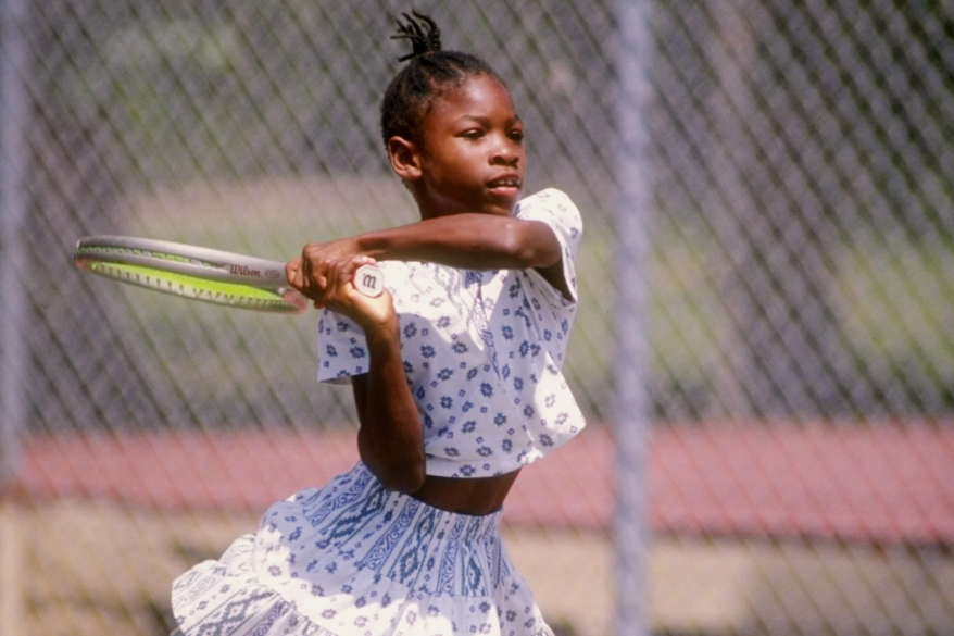 A young Serena Williams is seen practicing on the tennis court in 1992.