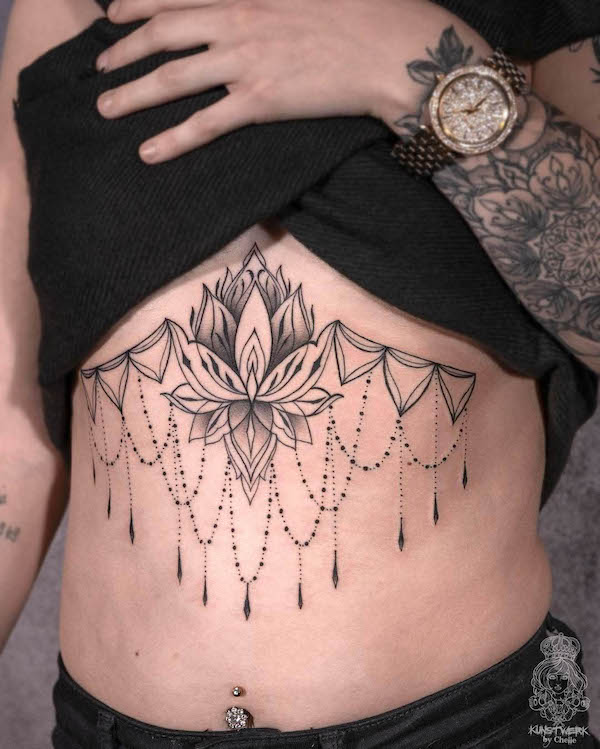 Bold lotus underboob tattoo by @kunstwerk.chelle