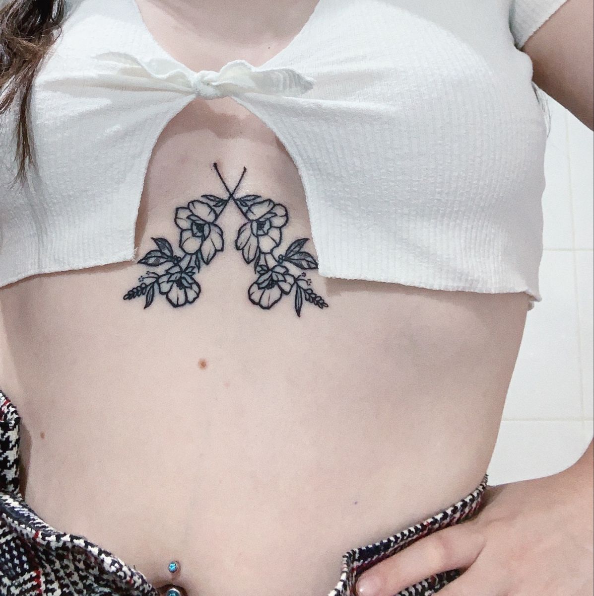 Botanical fine line flower piece on the sternum