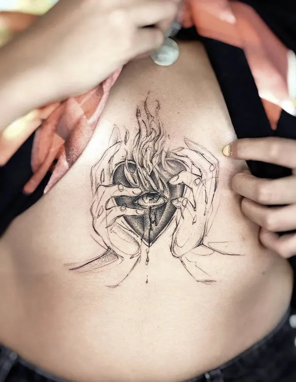 Burning sacred heart underboob tattoo by @paolameyertattoo