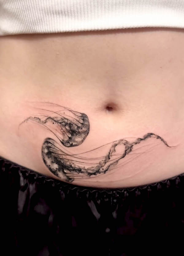 Cover-up jellyfish tummy tuck tattoo by @ink.feb24