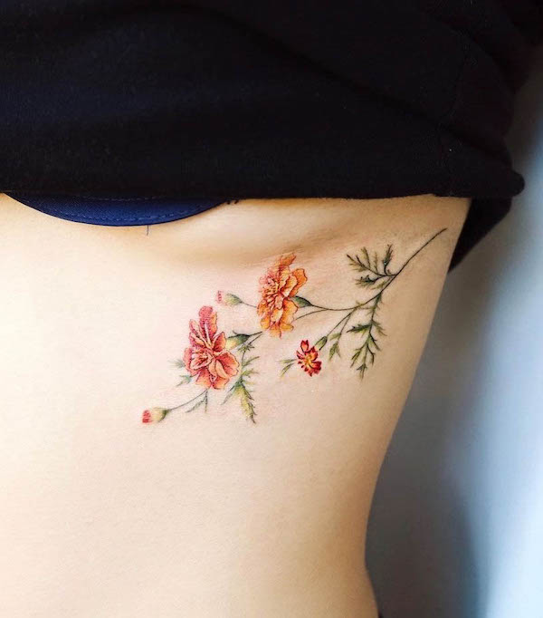 Cute colored flowers underboob tattoo by @vane.tattoo