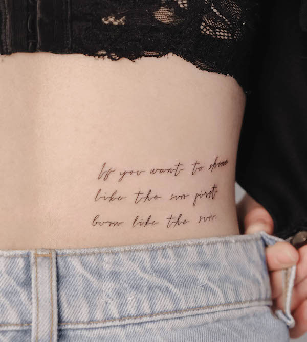 Meaningful quote waist tattoo by @elif.inkk