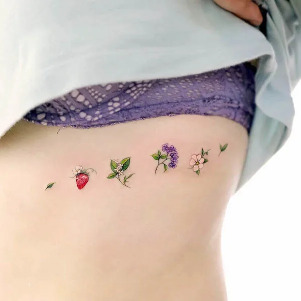 Small flower garden under the boob by @vane.tattoo