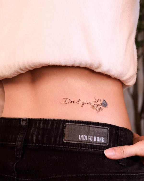 Small waistline quote tattoo by @noul_tattoo