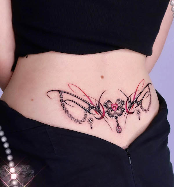 Spikes and heart lower back tattoo by @y2k_tattoo