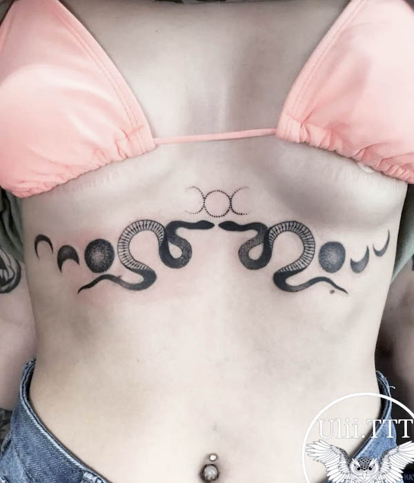 Symmetrical snake and moon underboob tattoo by @ulii.ttt