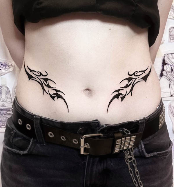 Symmetrical tribal waist tattoo for women by @gora.tattoo