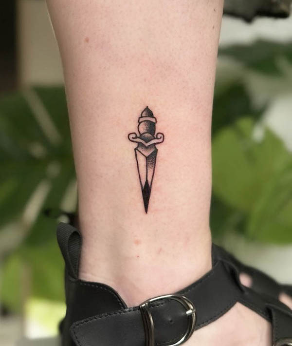 Tiny dagger ankle tattoo by @lovemore.tattoo