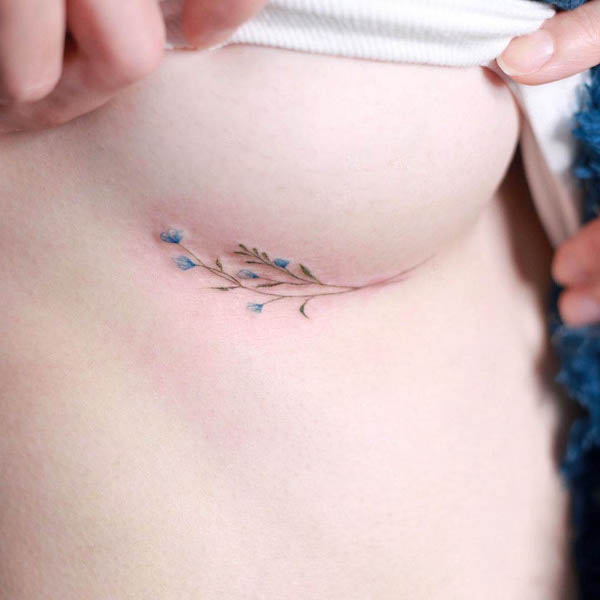 Tiny underboob flower tattoo by @tattooist_naro