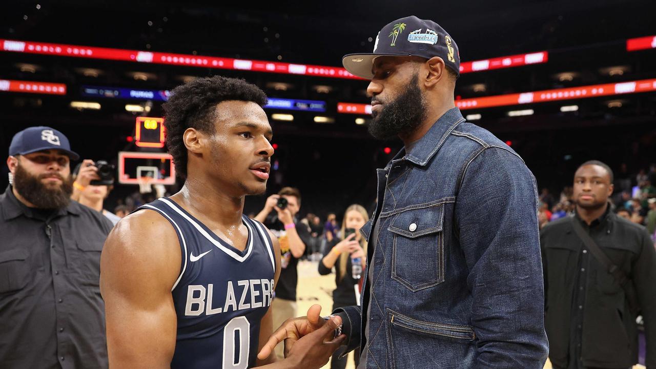 Bronny is greeted by LeBron after defeating the the Perry Pumas in the Hoophall West tournament at Footprint Center. (Photo by Christian Petersen / GETTY IMAGES NORTH AMERICA / AFP)