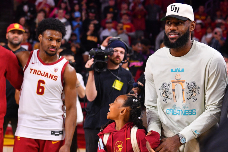 LOS ANGELES, CA - DECEMBER 10: Los Angeles Lakers forward Lebron James and his daughter Zhuri Nova walk past USC Trojans guard Bronny James (6) before the college basketball game between the Long Beach State 49ers and the USC Trojans on December 10, 2023 at Galen Center in Los Angeles, CA. (Photo by Brian Rothmuller/Icon Sportswire via Getty Images)