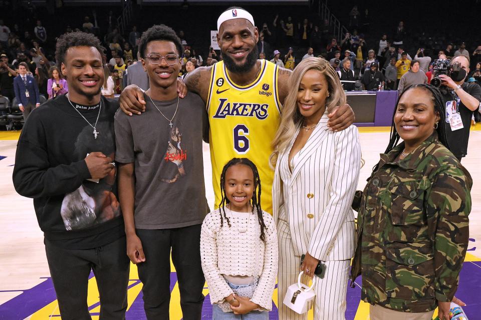 LeBron James #6 of the Los Angeles Lakers poses for a picture with his family at the end of the game, (L-R) Bronny James, Bryce James, Zhuri James Savannah James and Gloria James, passing Kareem Abdul-Jabbar to become the NBA's all-time leading scorer, surpassing Abdul-Jabbar's career total of 38,387 points against the Oklahoma City Thunder at Crypto.com Arena on February 07, 2023 in Los Angeles, California.