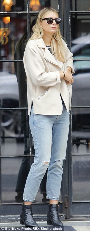 Edgy: Russian star Maria, layered up in a smart cream jacket which she teamed with a striped shirt and ripped jeans