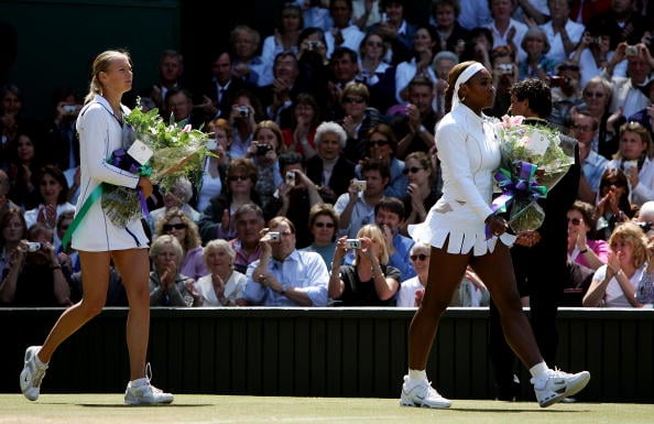 Maria Sharapova (L) and Serena Williams arrive on court moments before the ladies final match at the Wimbledon Lawn Tennis Championship on July 3, 2004. (Photo by Mike Hewitt/Getty Images)