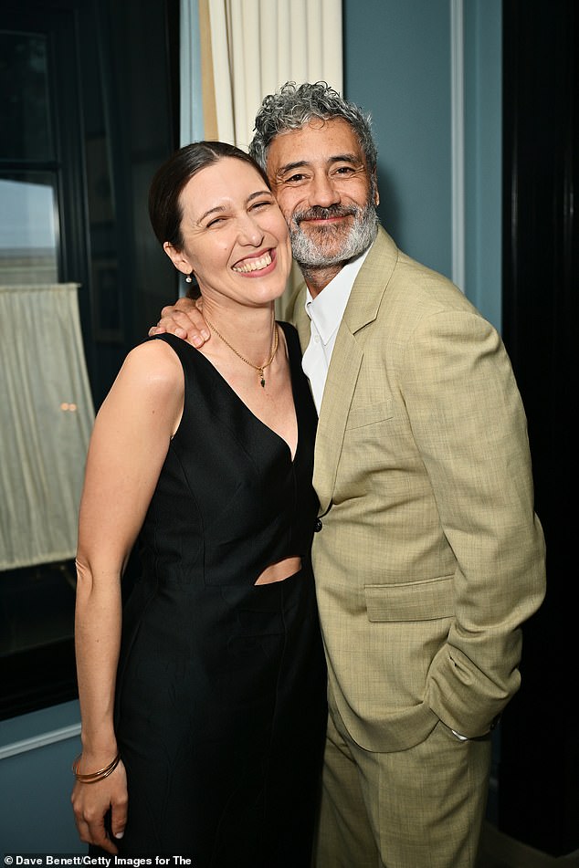 Her director husband Taika cut a dapper figure in a light green linen suit with a white button-up shirt underneath