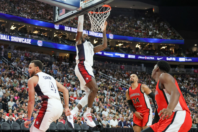 LAS VEGAS, NEVADA - JULY 10: LeBron James #6 of the United States dunks ahead of Dillon Brooks #24 and RJ Barrett #9 of Canada off of an alley-oop pass from Stephen Curry #4 in the second half of their exhibition game ahead of the Paris Olympic Games at T-Mobile Arena on July 10, 2024 in Las Vegas, Nevada. The United States defeated Canada 86-72. (Photo by Ethan Miller/Getty Images)