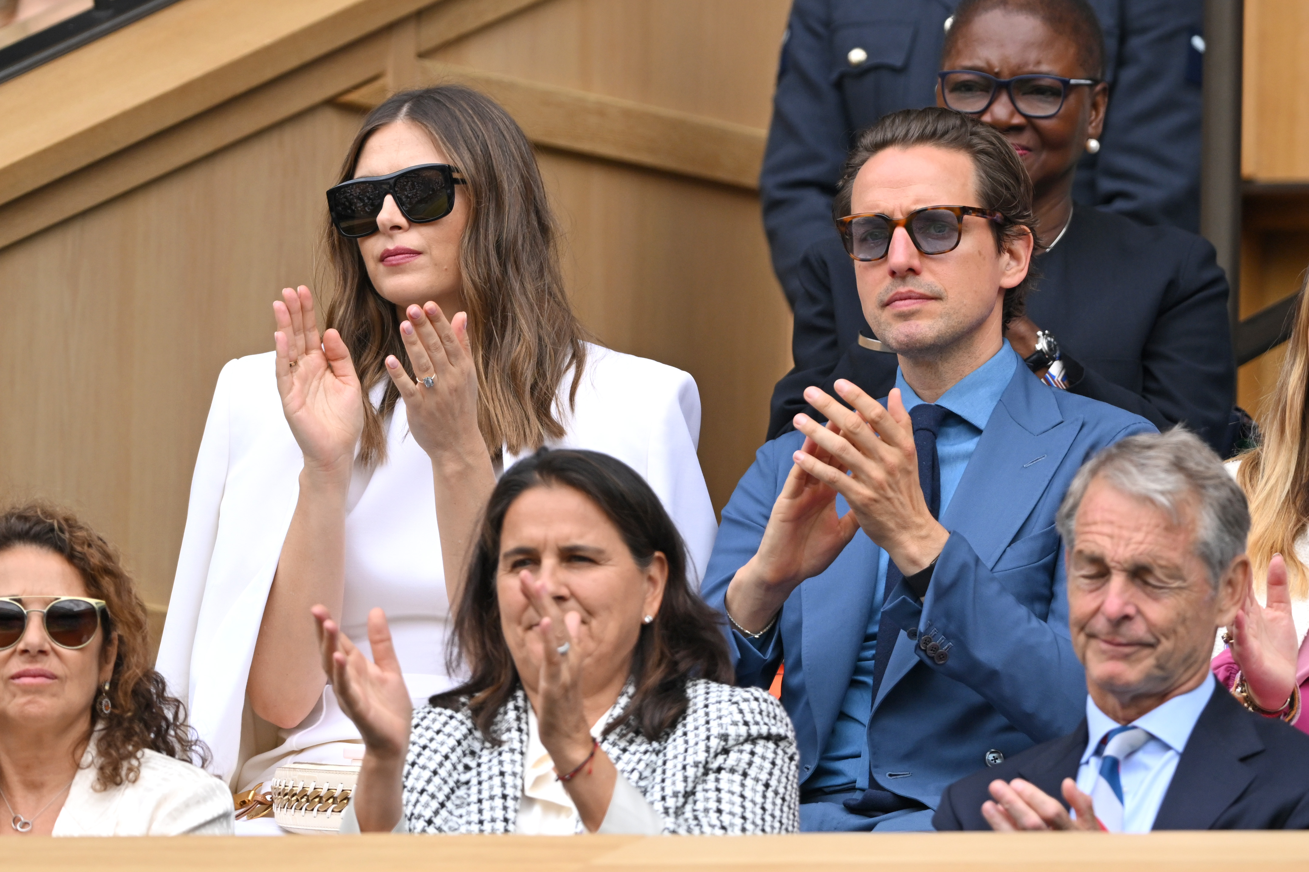 She was seated next to her fiance Alexander Gilkes