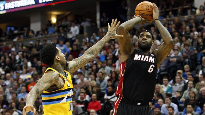 Dec 30, 2013; Denver, CO, USA; Miami Heat small forward LeBron James (6) takes a shot against Denver Nuggets shooting guard Wilson Chandler (21) in the third quarter at the Pepsi Center. The Heat defeated the Nuggets 97-94. Mandatory Credit: Isaiah J. Downing-USA TODAY Sports