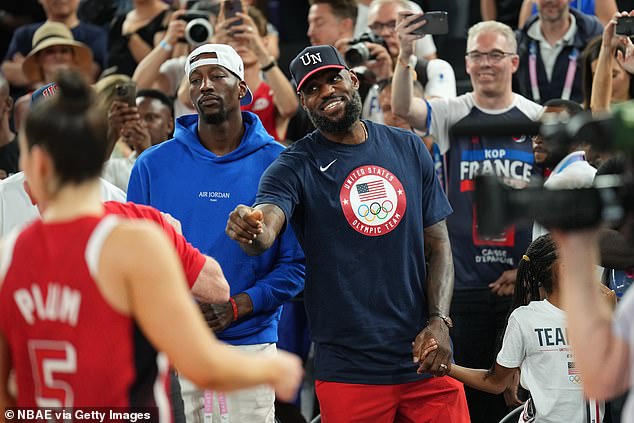 Bam Adebayo and LeBron James (right) watch the American women take gold in Paris