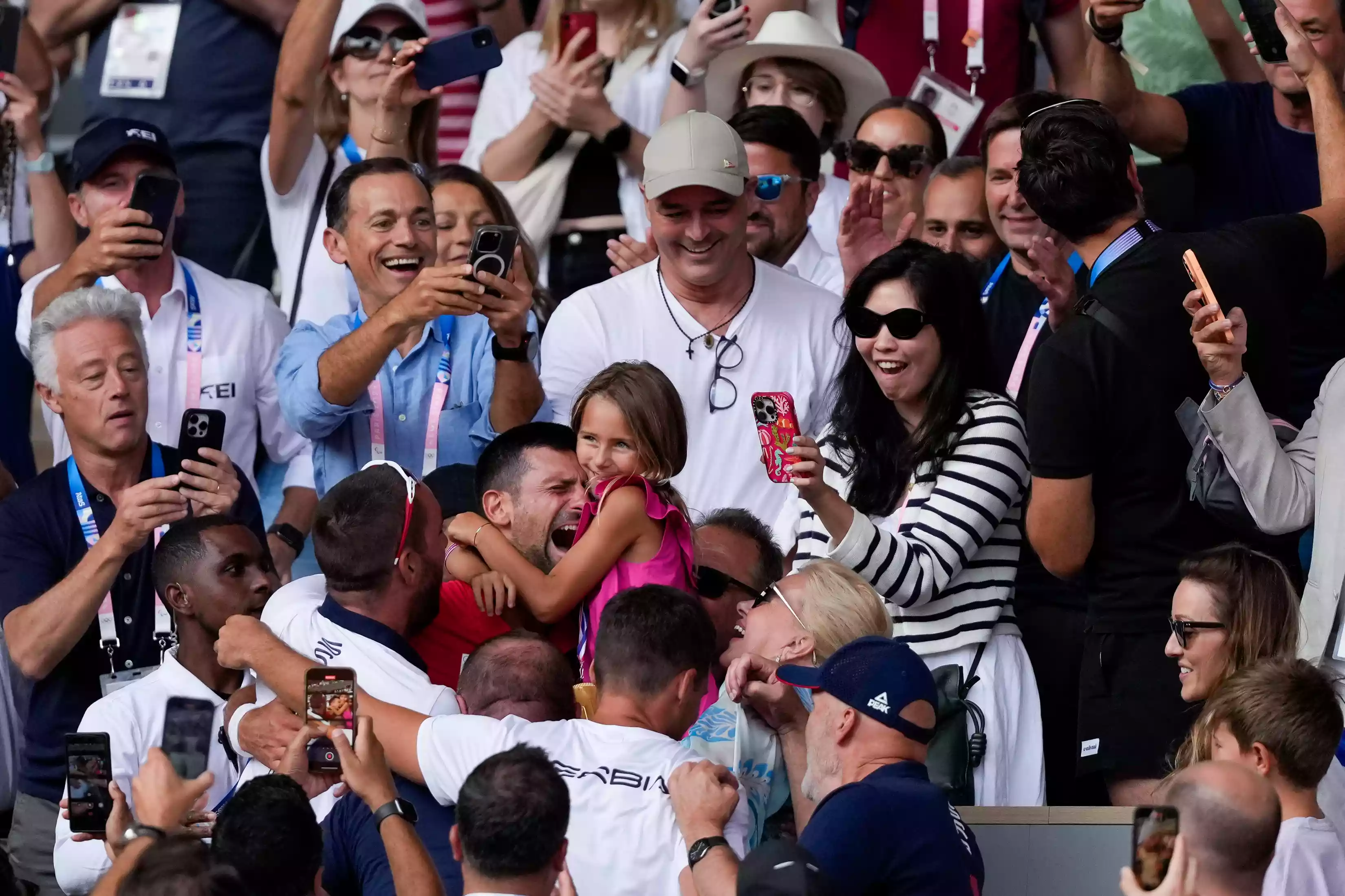 Novak Djokovic of Serbia celebrates with his family in the stands his victory of the Final and gold medal win