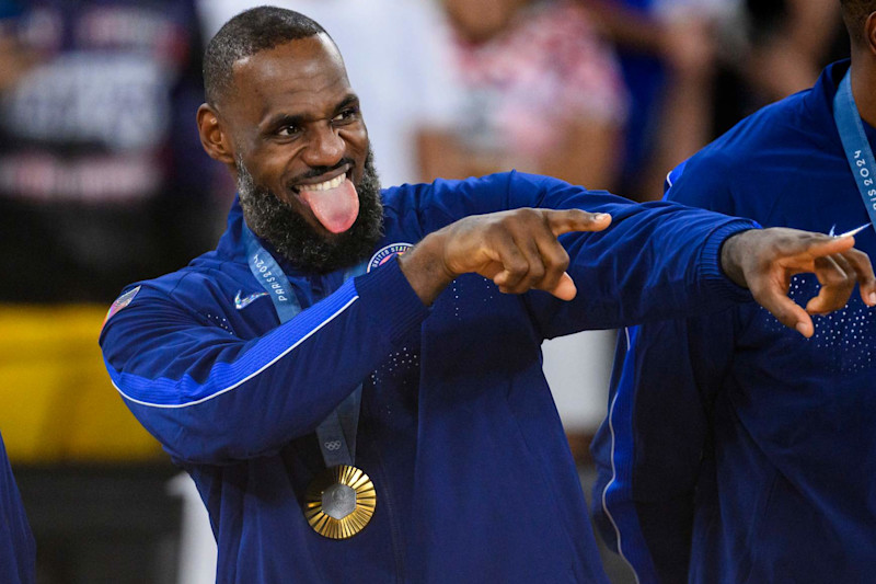 PARIS, FRANCE - AUGUST 11: Gold medalist LeBron James of Team United States celebrate on the podium during the Men's basketball medal ceremony on day fifteen of the Olympic Games Paris 2024 at the Bercy Arena on August 11, 2024 in Paris, France. (Photo by Tom Weller/VOIGT/GettyImages)