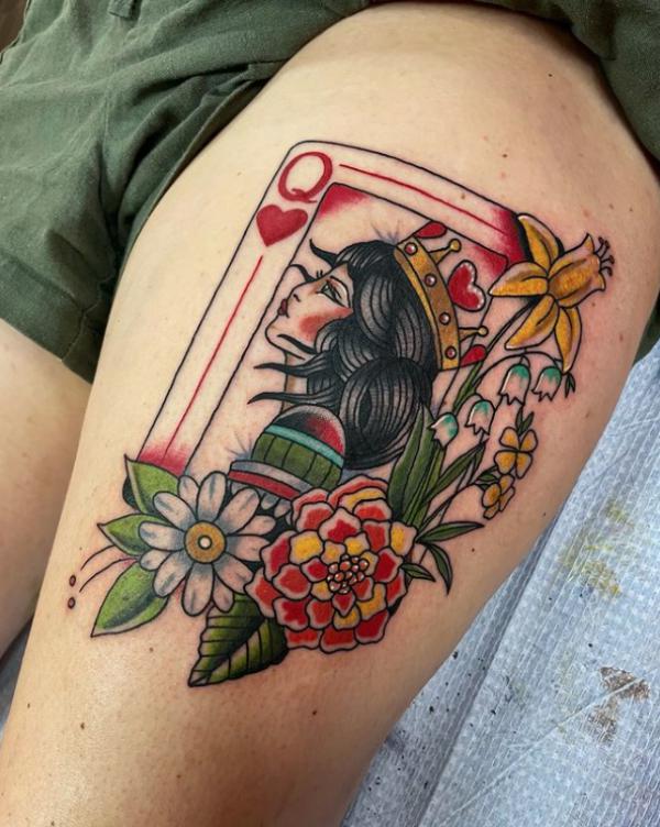 Queen of hearts playing card with flowers tattoo thigh