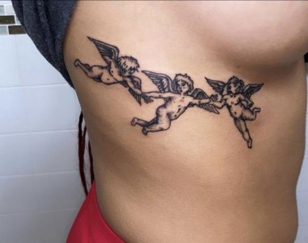 Three cherub Be side boob tattoo