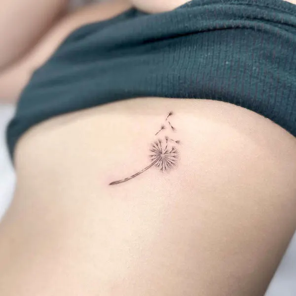 Small dandelion rib tattoo by @tattoosbyeden